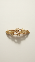 Gold-accented hair accessory with sleek finish